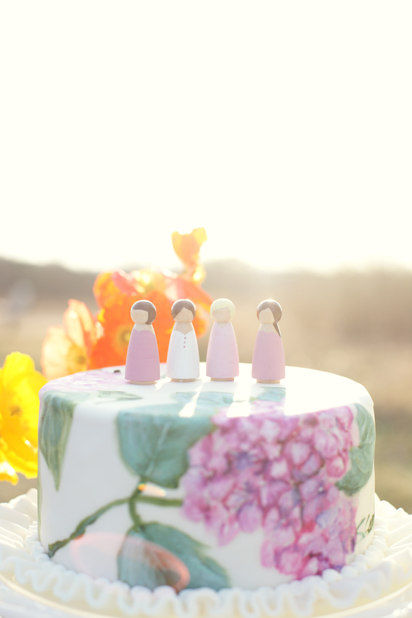 Wooden peg dolls on top of a hand painted bridesmaid cake | Maine Wedding & Portrait Photographer
