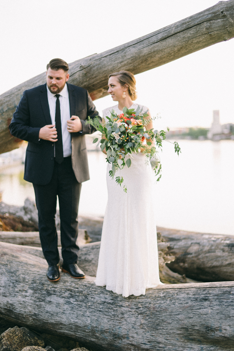 Bride and Groom on driftwood at Minnesota Boat Club