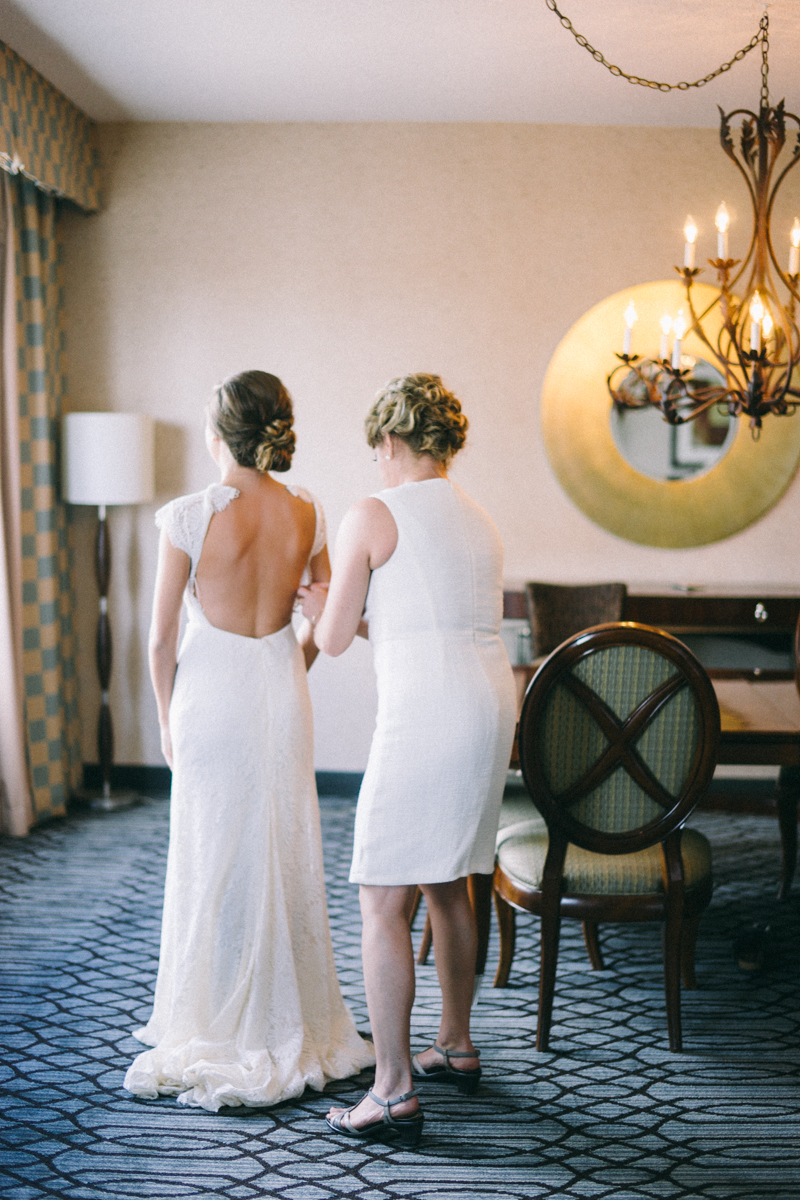 Mom helping bride get dressed for St Paul wedding