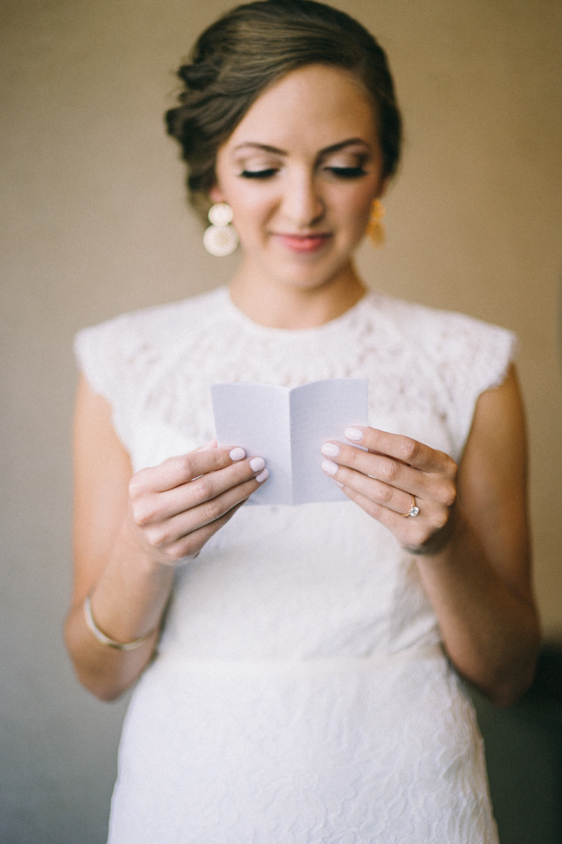 Bride reading note from groom on wedding day