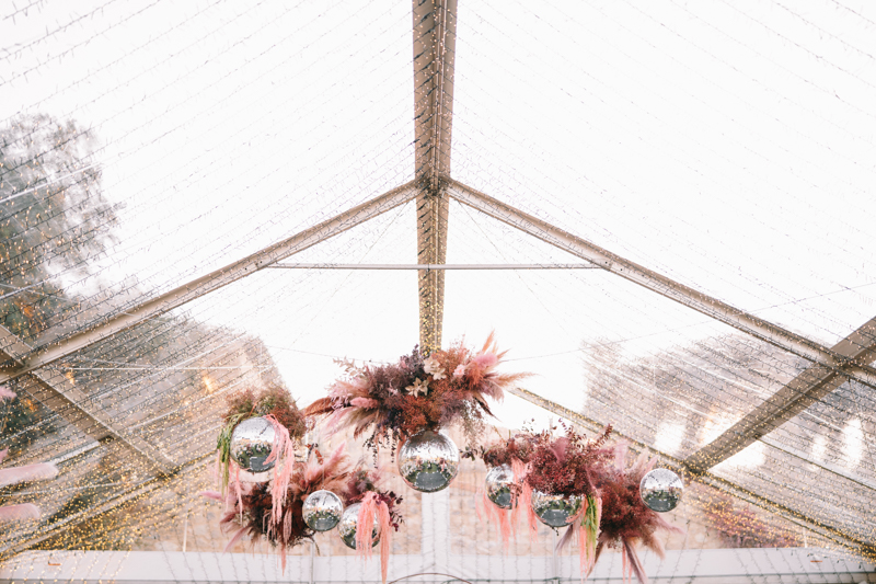 twinkle tent with disco balls and dried floral