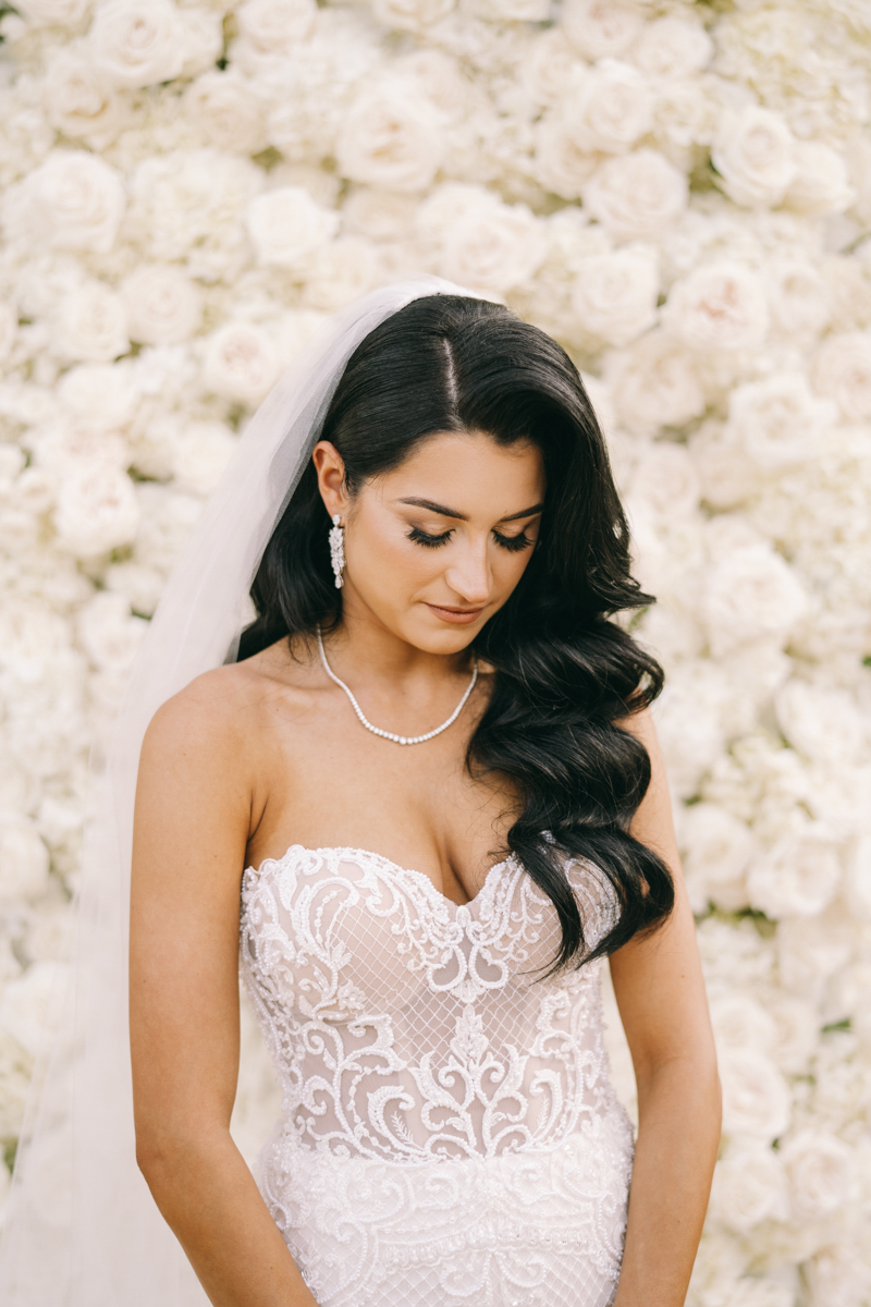 bride photo in front of rose wall