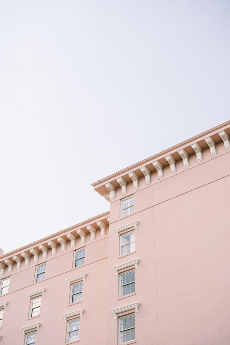 Pink building in downtown Charleston against blue sky