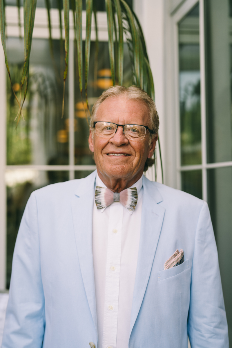 Smiling father of the bride in blue suit and bowtie
