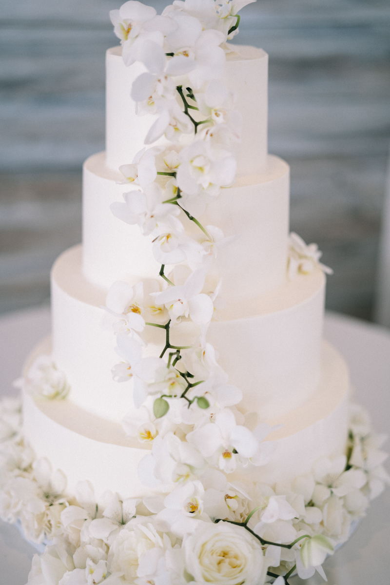 white cake with orchids