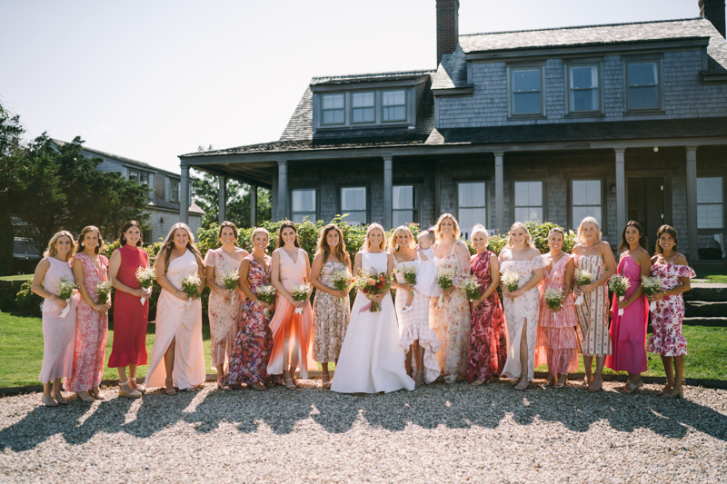 bride and bridesmaids standing together with flowers