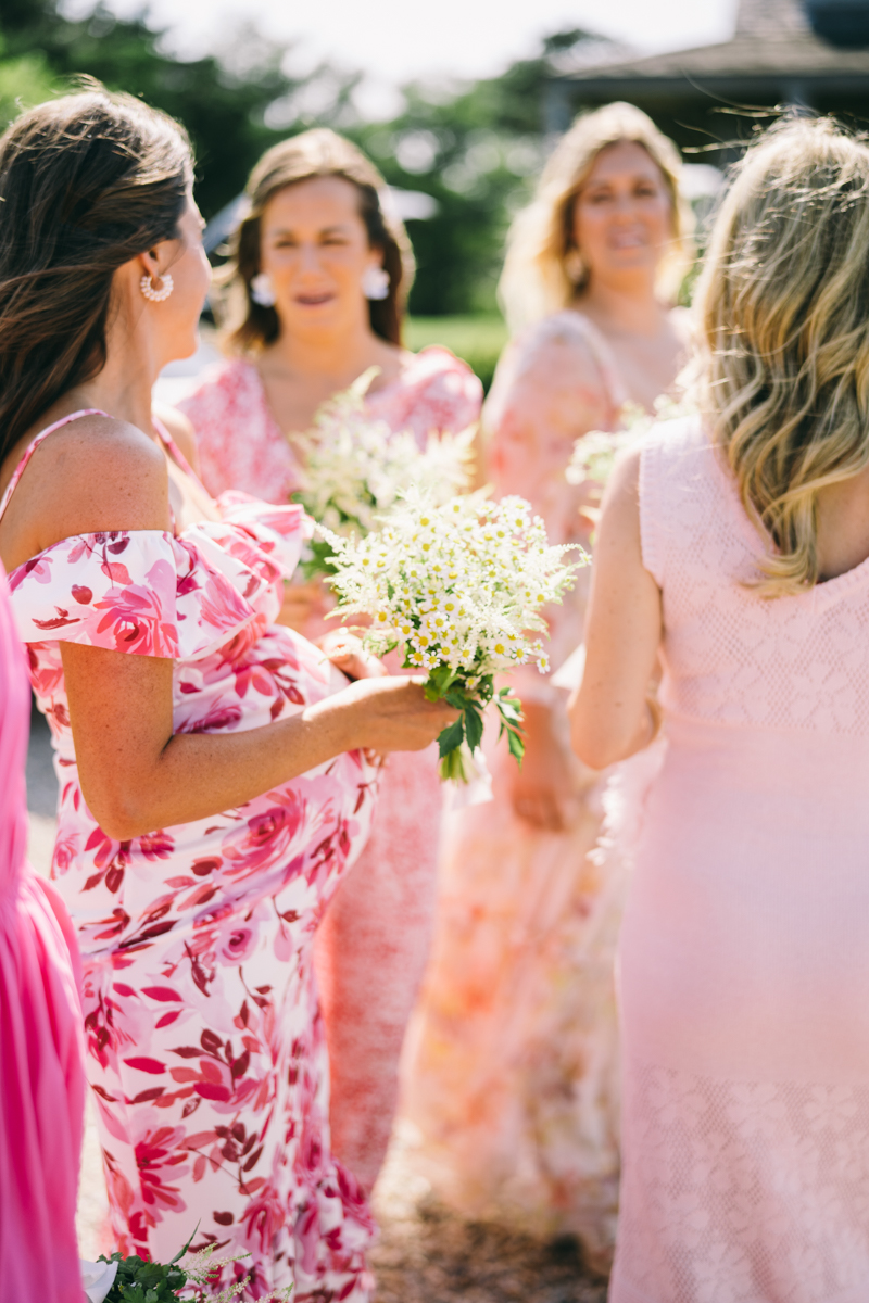 bridesmaids in pinks holding their flowers