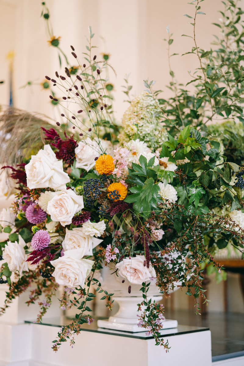white, pink, green, and golden flowers at altar