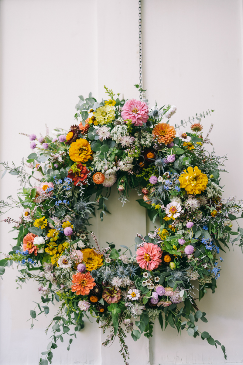 flower wreath with pink, gold, blue, and purple flowers