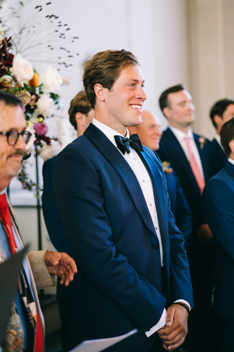 groom smiling at the altar waiting for the bride