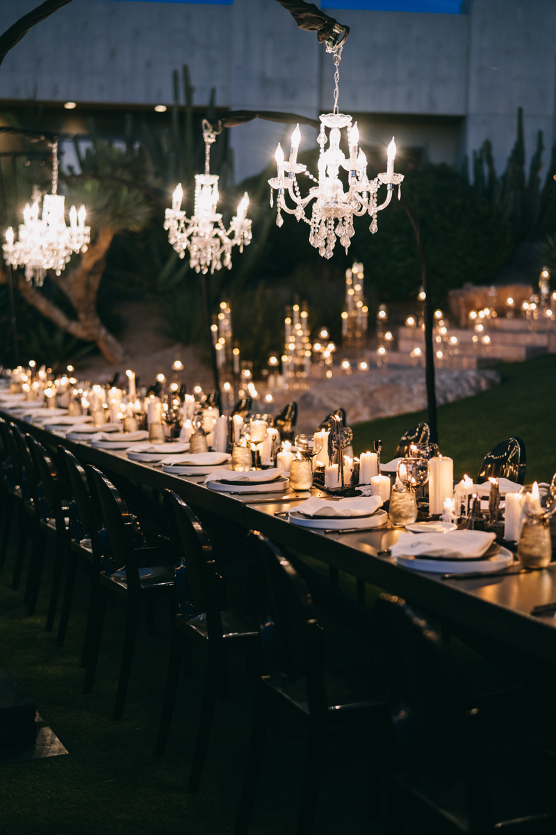 outdoor wedding reception with candles and chandeliers