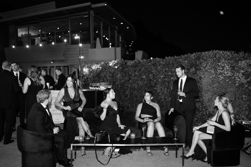 black and white photo of guests mingling at wedding reception