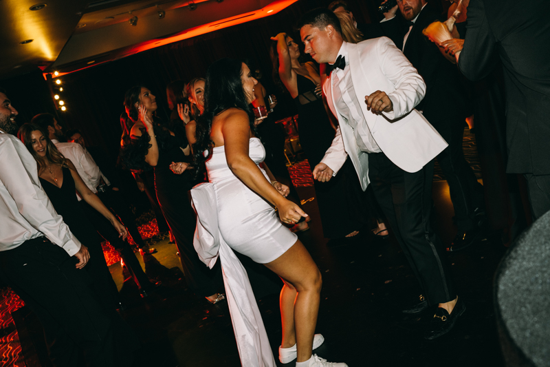 bride and groom on the dance floor dancing with guests