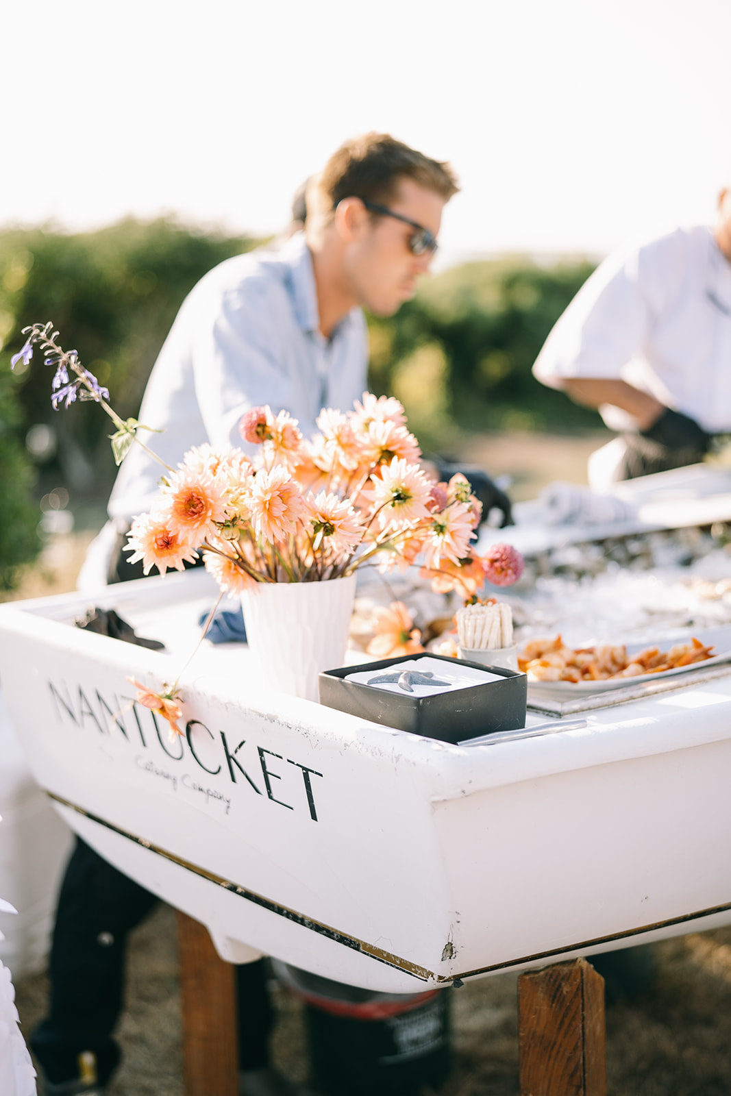 Appetizer bar in a small boat named 'Nantucket' with pink daisies 