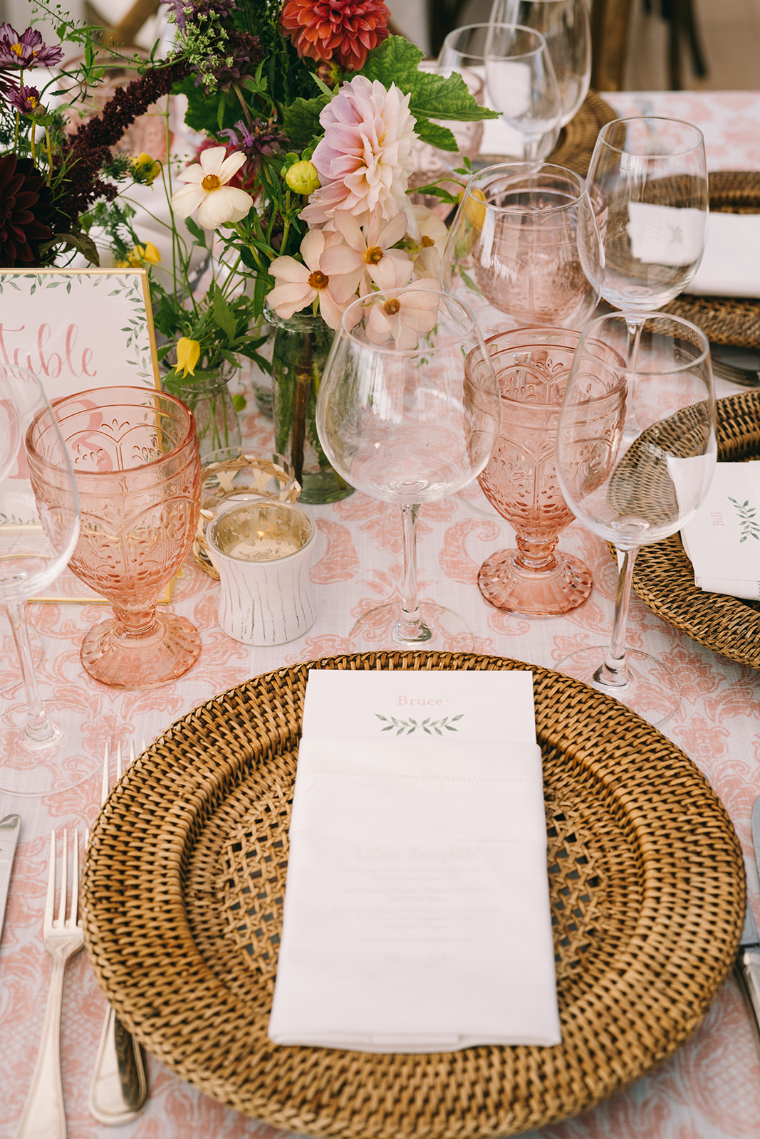 Luxury wedding table setting with wild flowers and pink water goblets