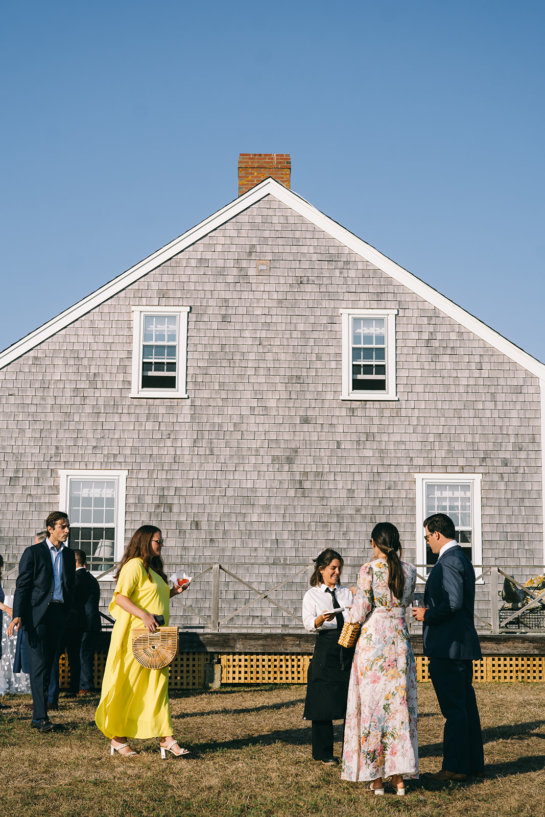 Nantucket wedding reception guests outside eating hors d'oeurves 