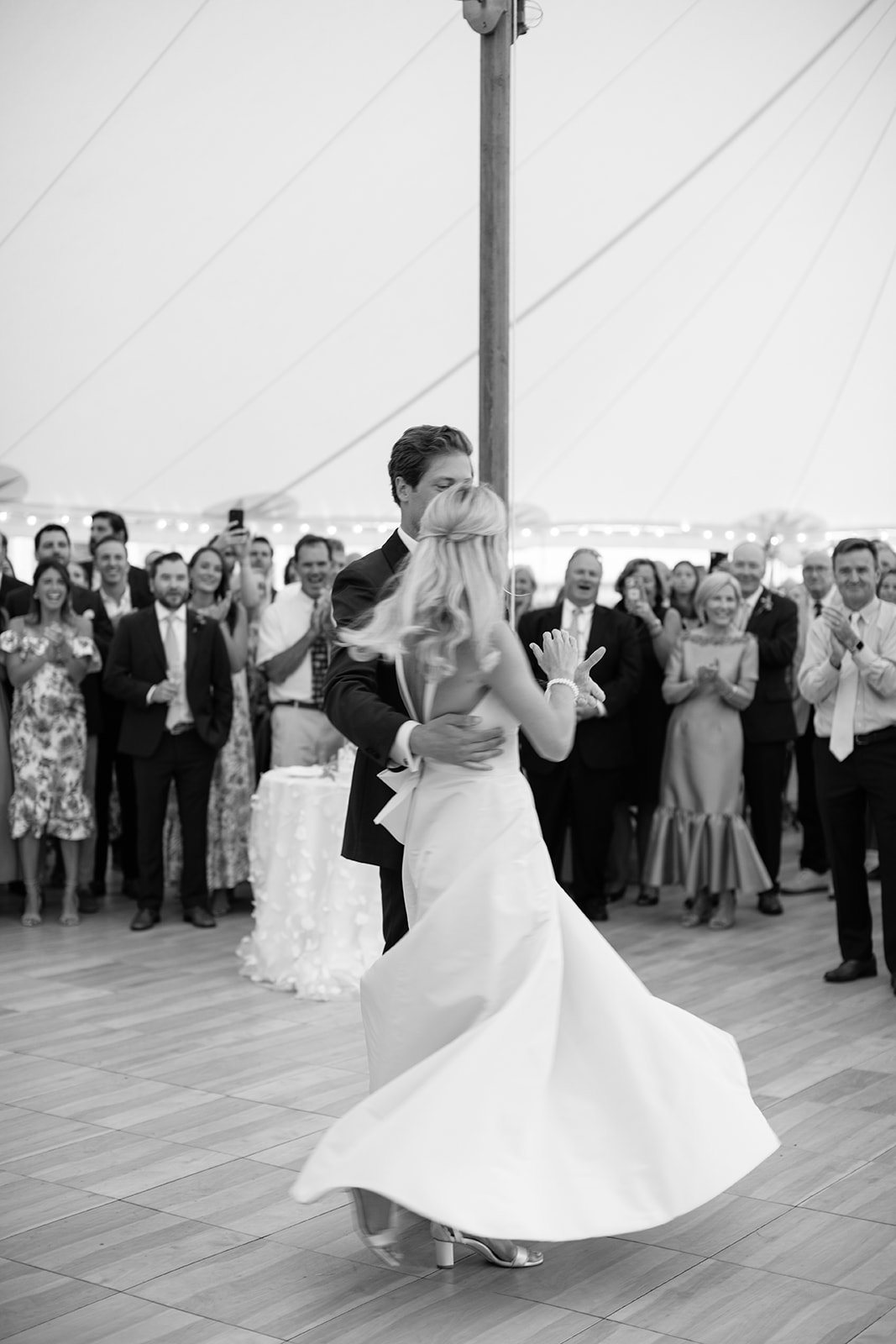 Bride and groom sharing a first dance on the dance floor with the bride's dress twirling 