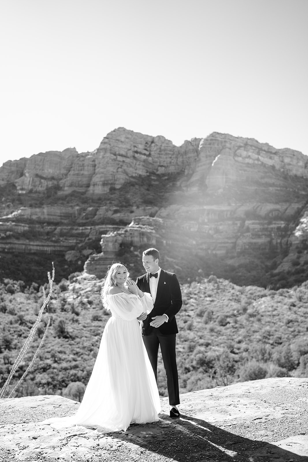 Bride and groom standing together while the groom is looking at bride 