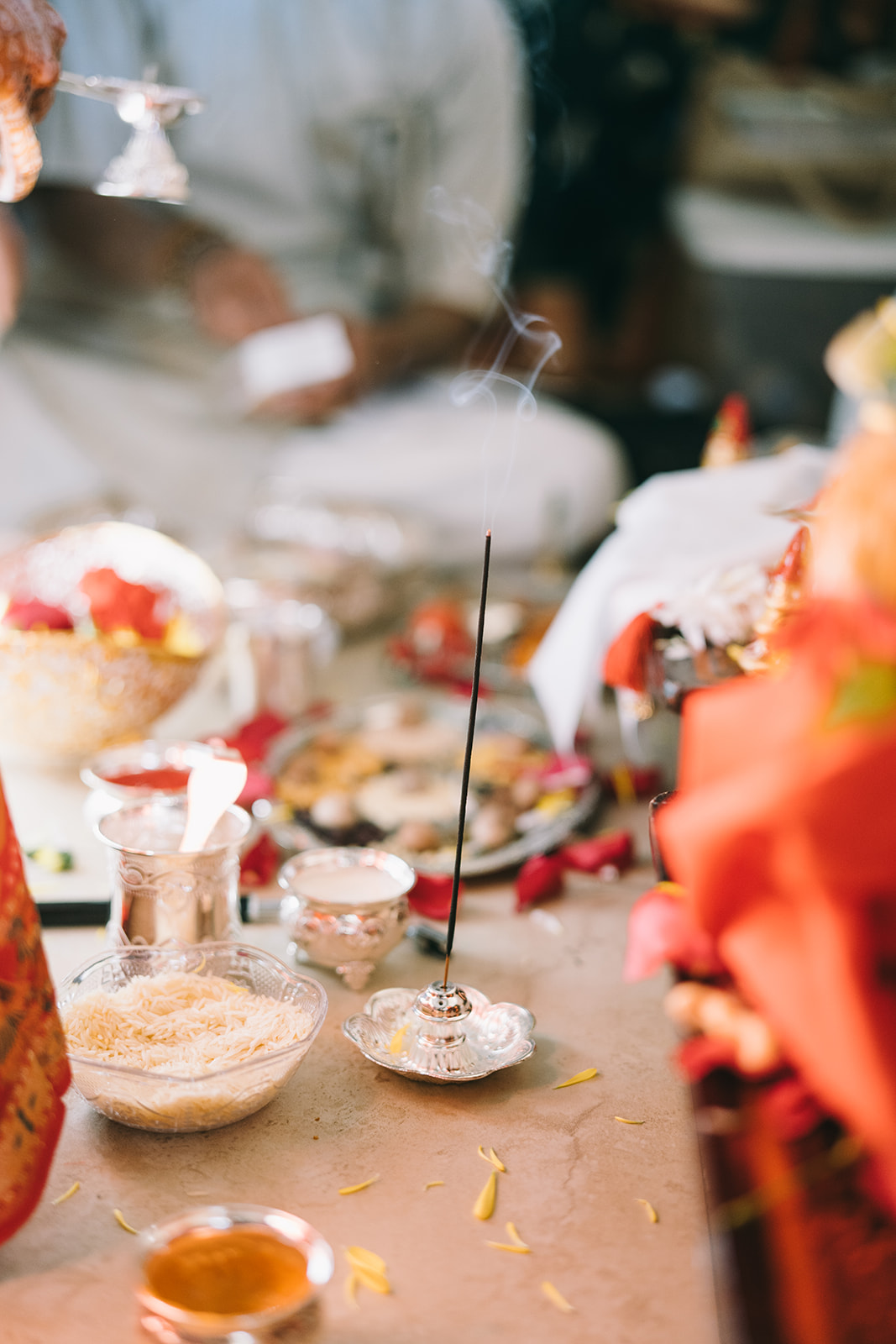 Indian wedding ceremony incense burning with rice and flower petals 