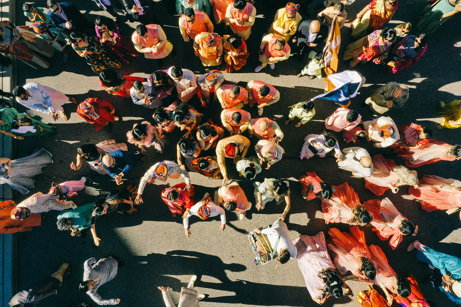 Aerial view of people in colorful clothing walking in a procession