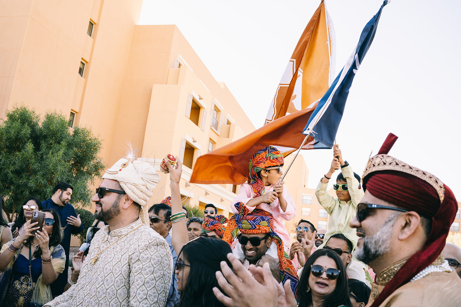 Candid of people walking in processional while waving flags