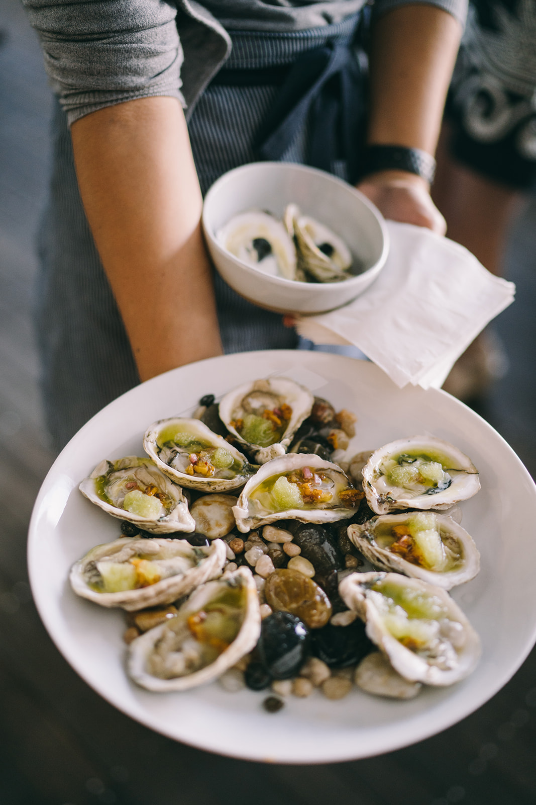 Stuffed fresh oysters being presented on a plate