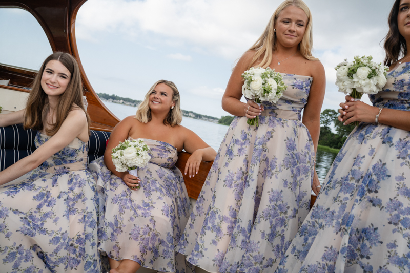 bridal party taking a boat to reception