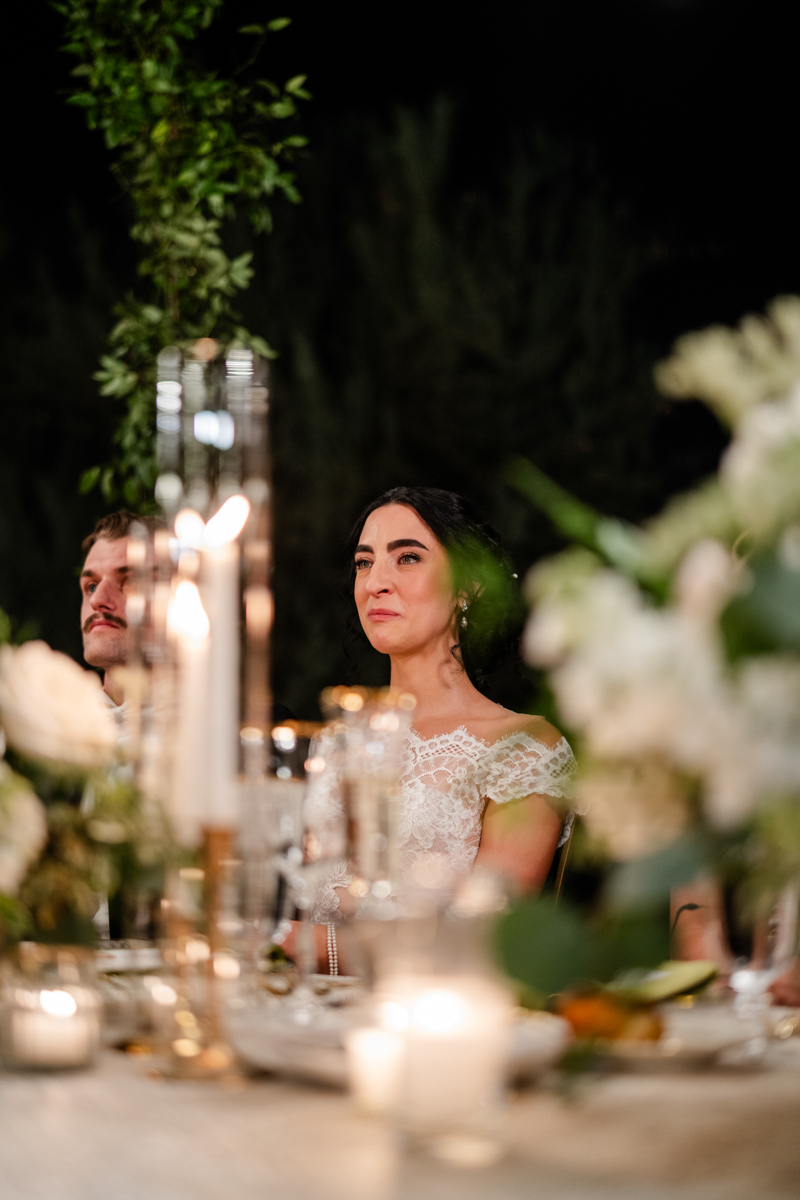 bride listening to speeches at reception