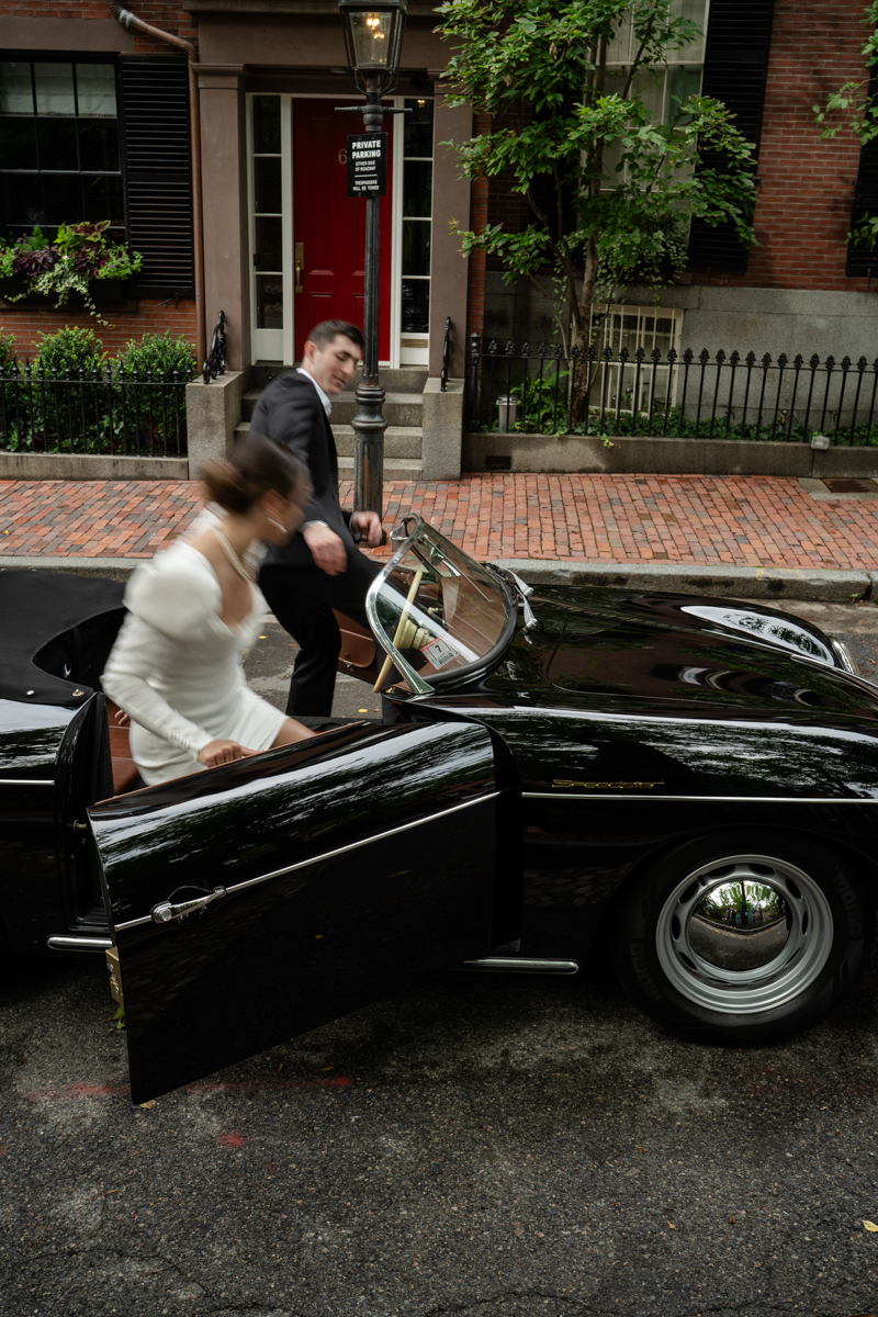 couple getting into vintage car