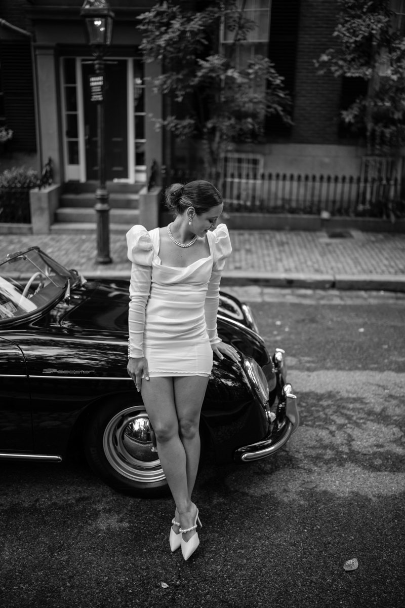 bride standing next to Porsche