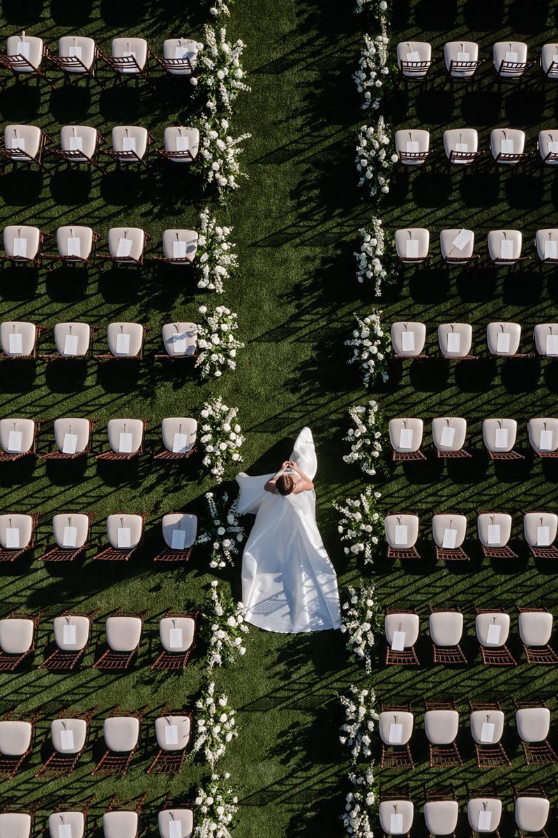 drone photo of bride walking down ceremony aisle