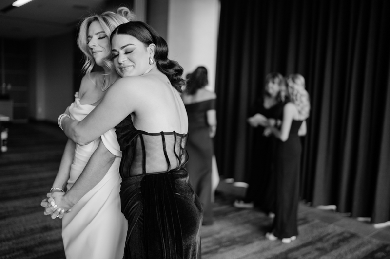 bride and maid of honor hugging