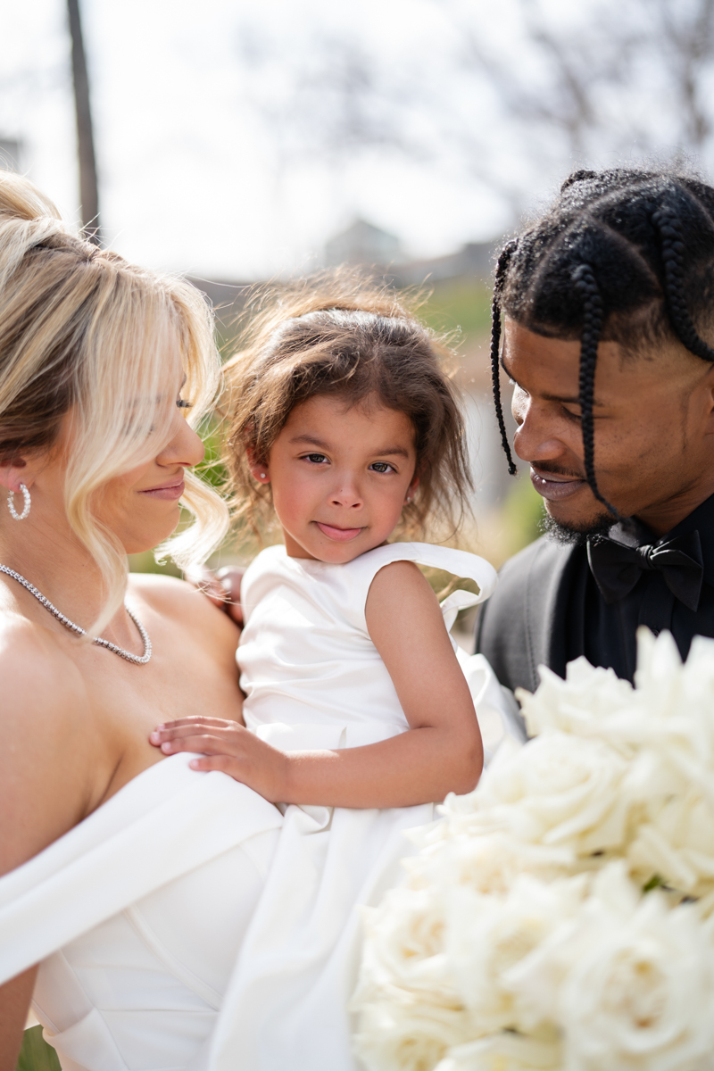 bride and groom with daughter