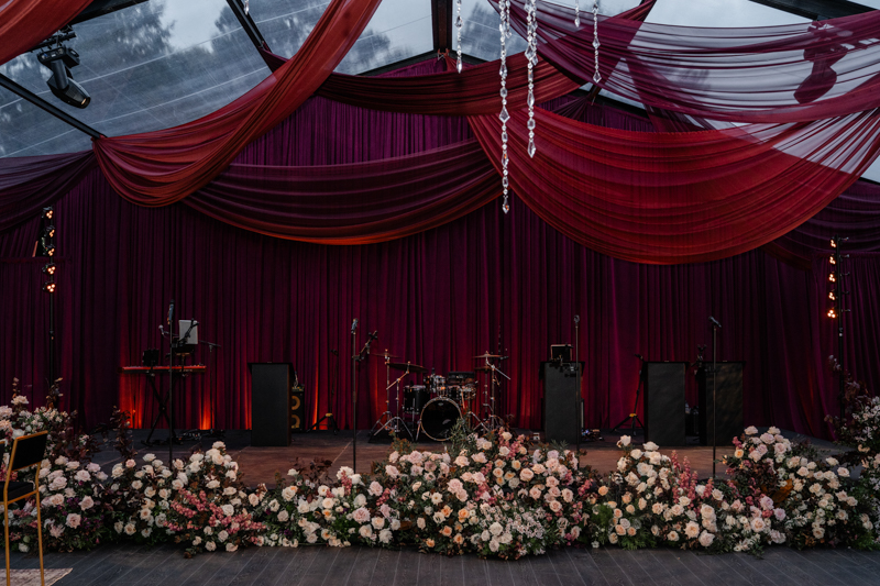 Tented maroon wedding with crystal chandelier