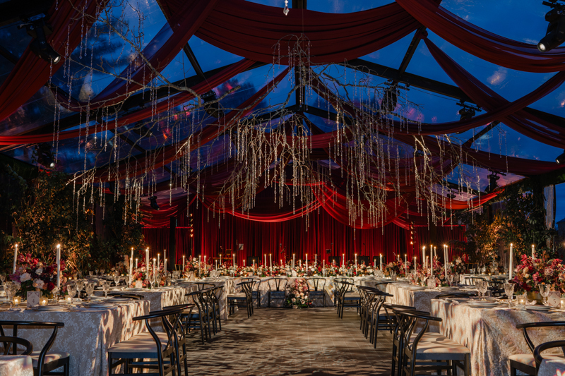 Tented maroon wedding with crystal chandelier