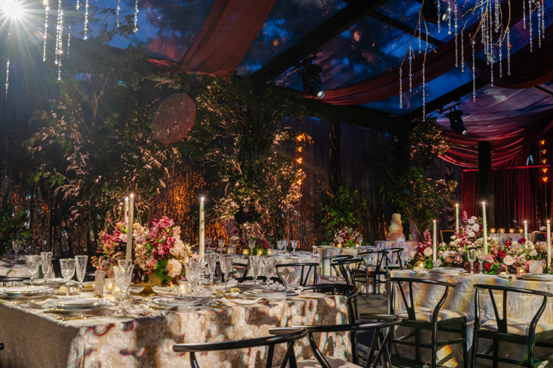 Tented maroon wedding with crystal chandelier