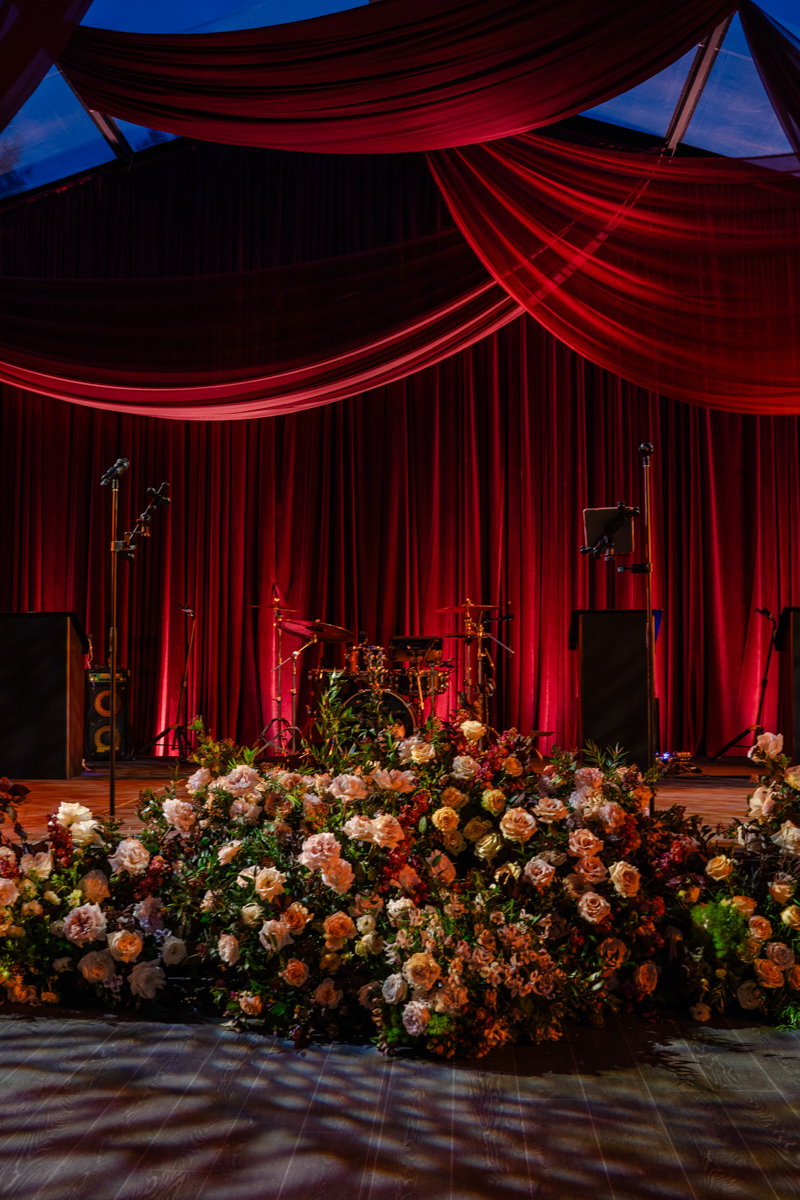 Tented maroon wedding with crystal chandelier