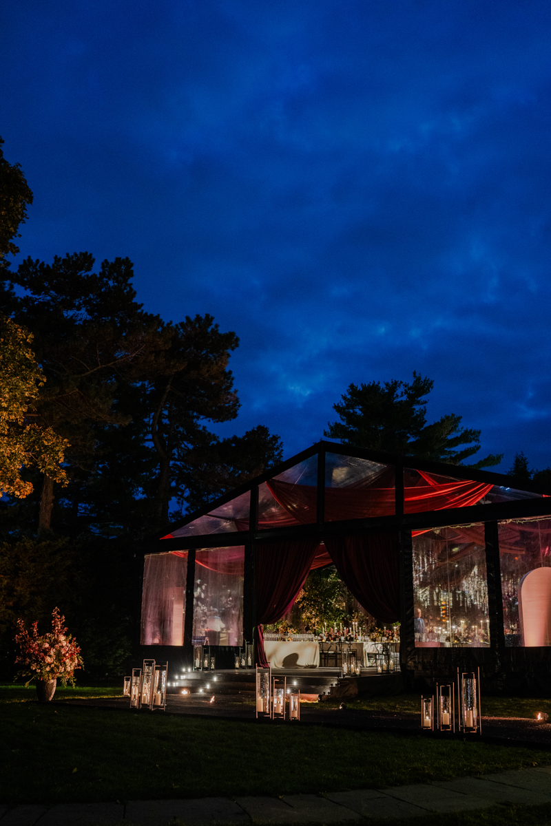 Tented maroon wedding with crystal chandelier