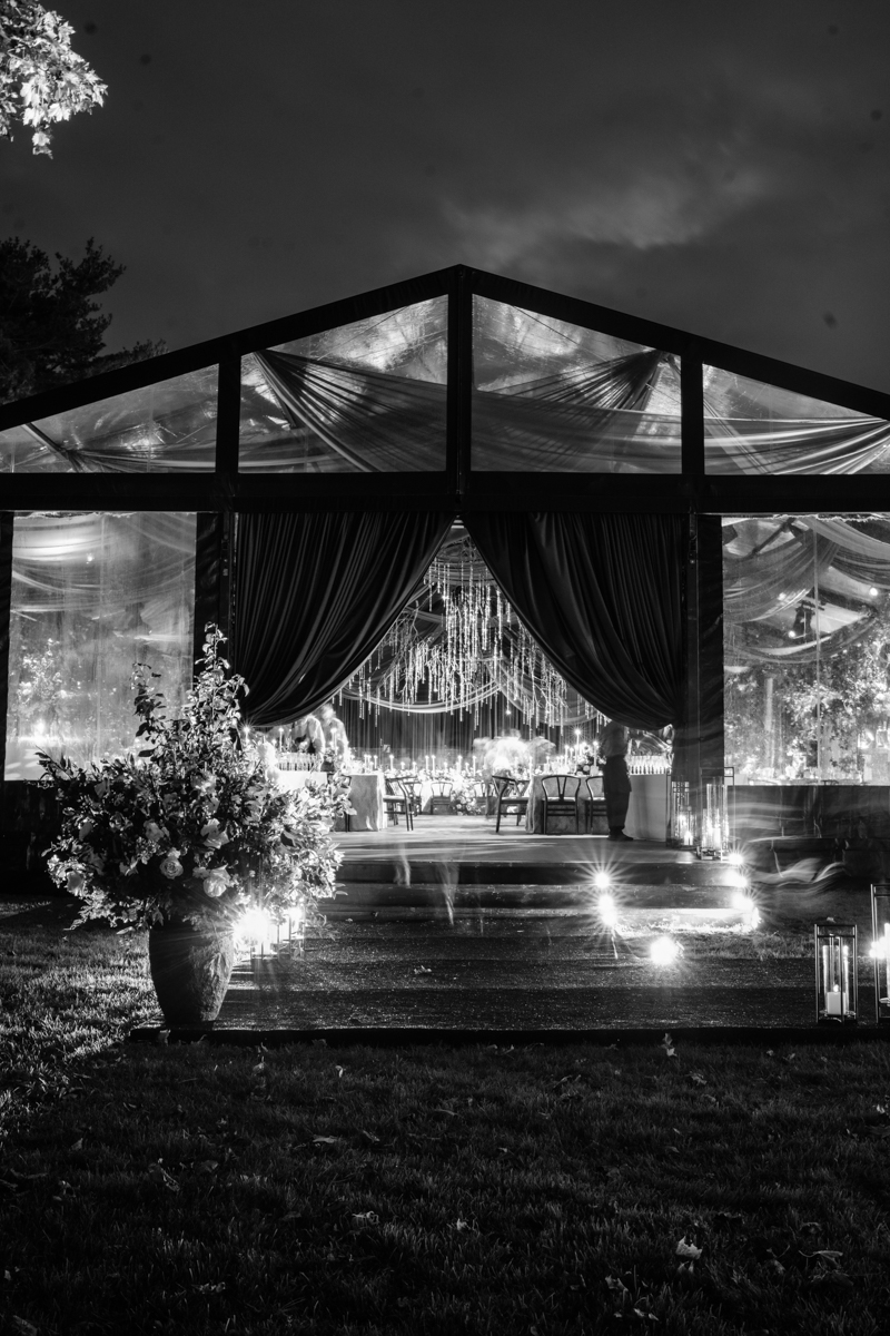 Tented maroon wedding with crystal chandelier