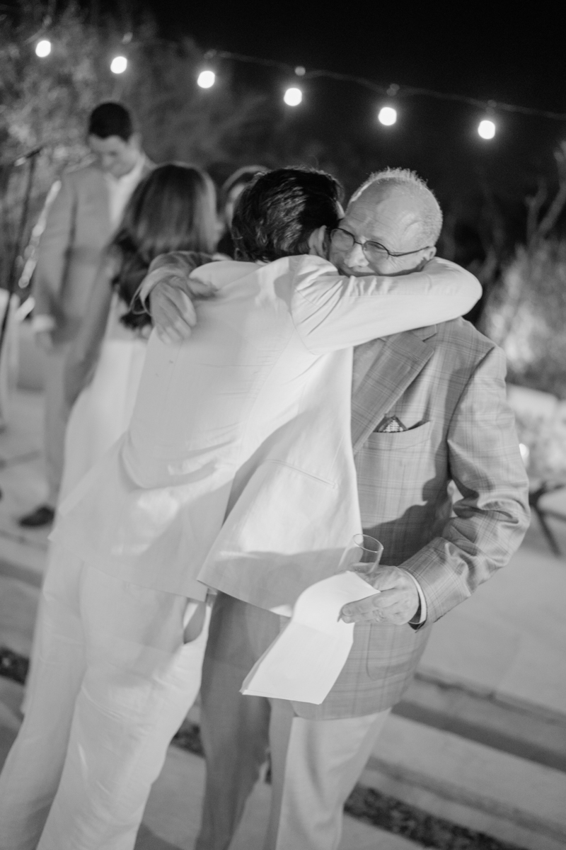 groom hugging dad