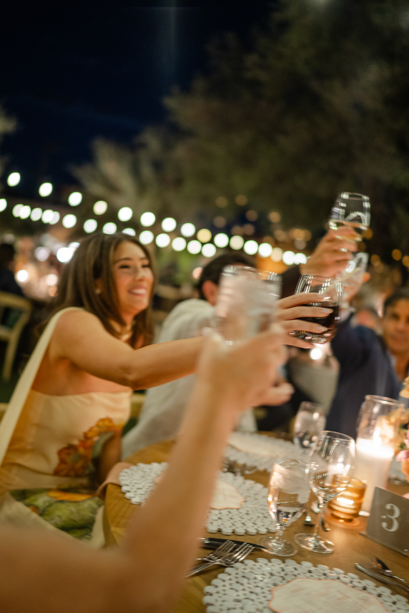 couple listening to speeches at rehearsal dinner