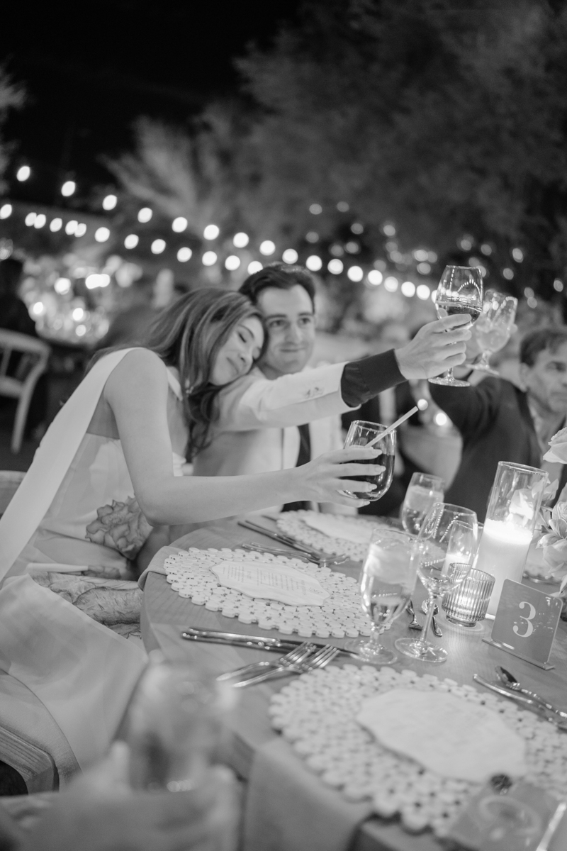 couple listening to speeches at rehearsal dinner