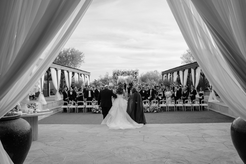 both parents walking bride down aisle at four seasons jewish ceremony