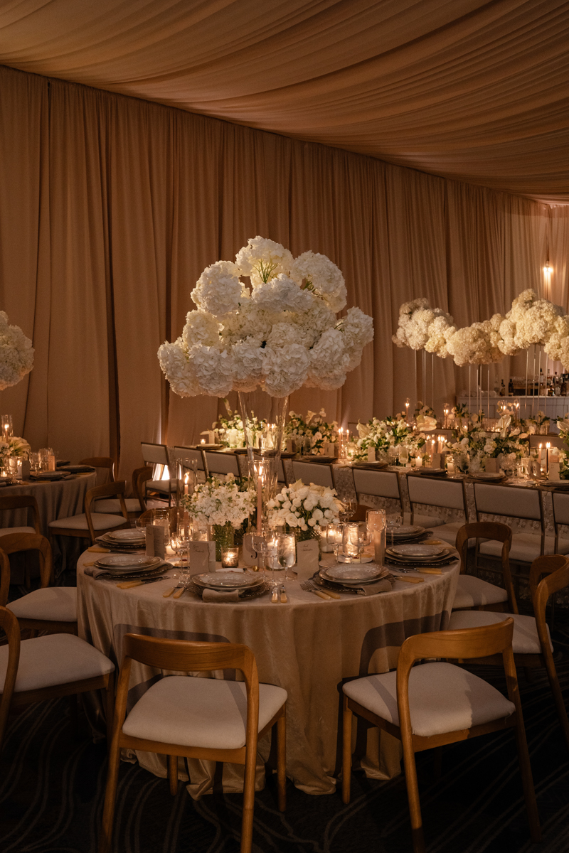 draped ballroom with candles and hydrangea centerpieces