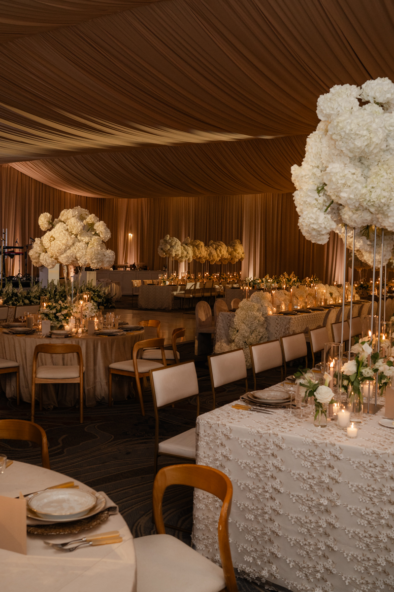 draped ballroom with candles and hydrangea centerpieces