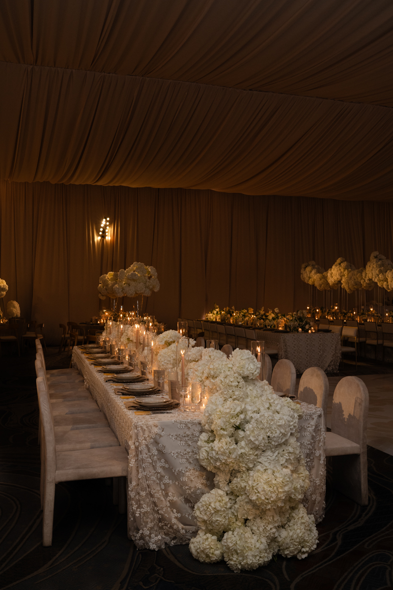 draped ballroom with candles and hydrangea centerpieces