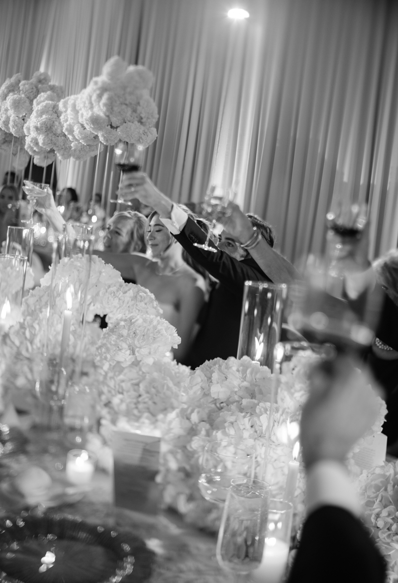 bride and groom watching speeches