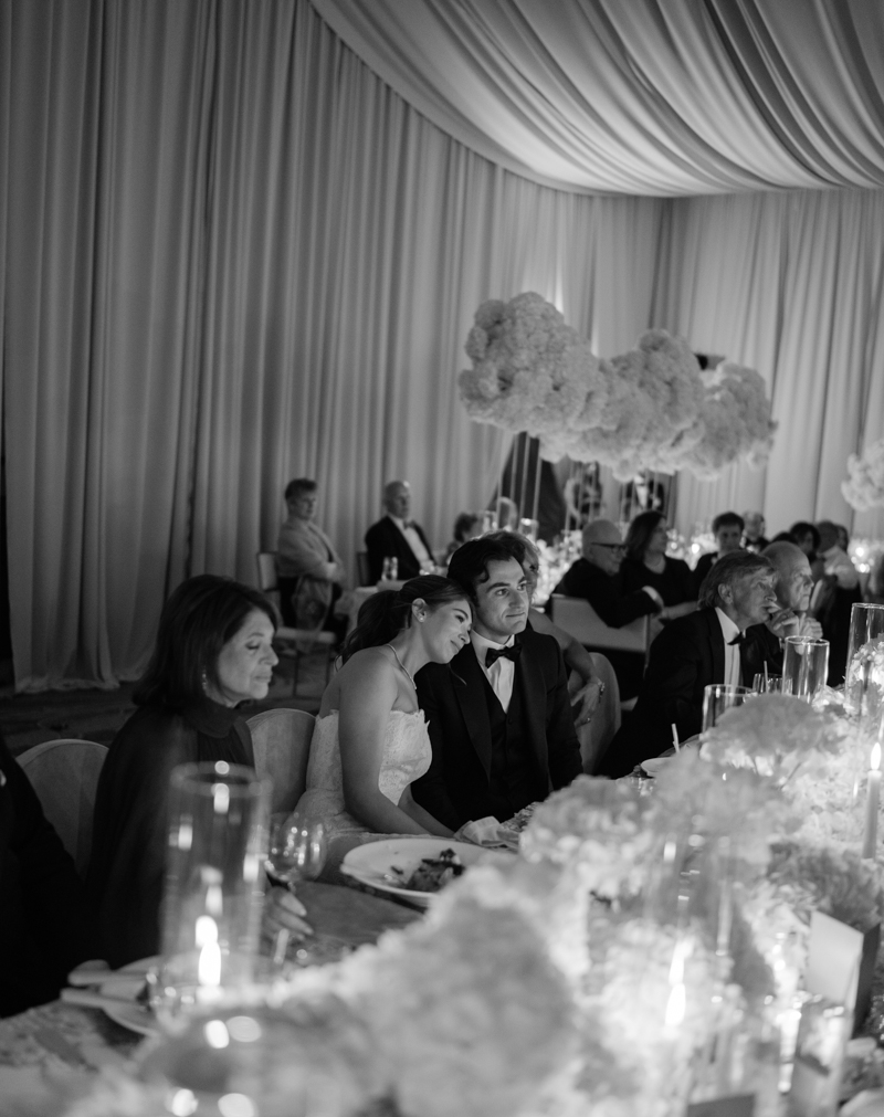 bride and groom watching speeches