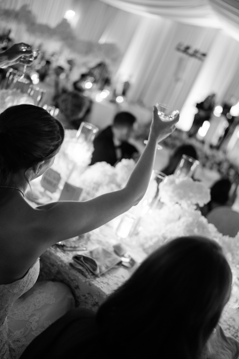 bride and groom watching speeches