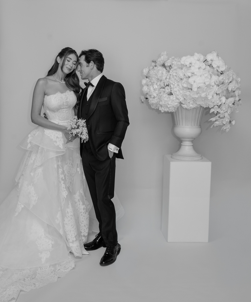 bride and groom editorial photos with floral piece
